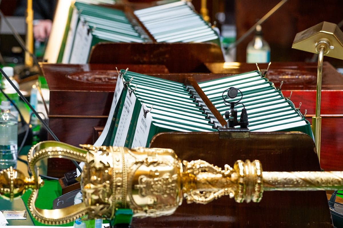 A close image of the centre table of the Legislative Assembly chamber, showing the mace and statue books.
